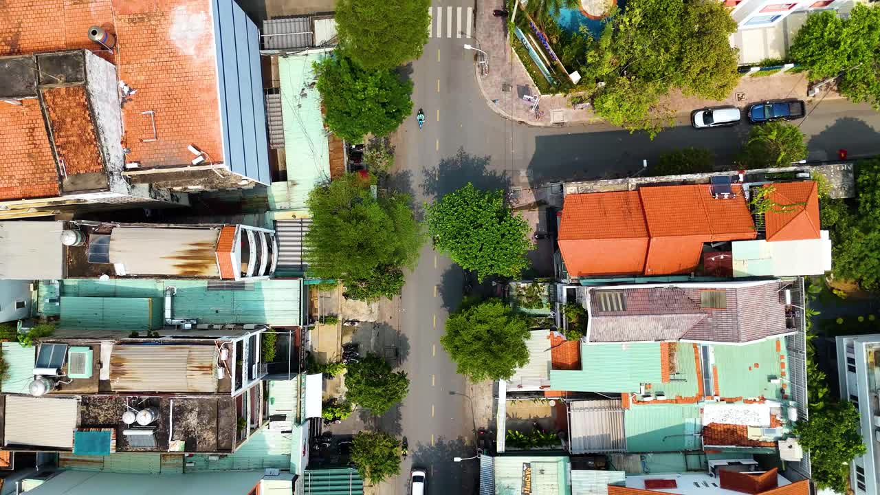 Top down aerial view of a residential area in Ho Chi Minh City (Saigon), Vietnam, with street traffic. Captures the urban landscape and daily life.