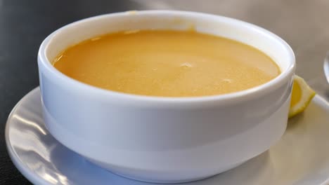 bowl of fish soup with lemon