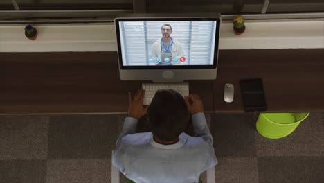 Overhead-view-of-man-having-a-video-conference-