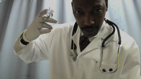 a doctor prepares to administer an injection with a needle