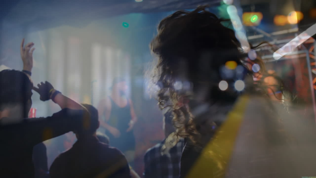 Silhouetted audience members raising hands in concert, with animated light beams for music industry