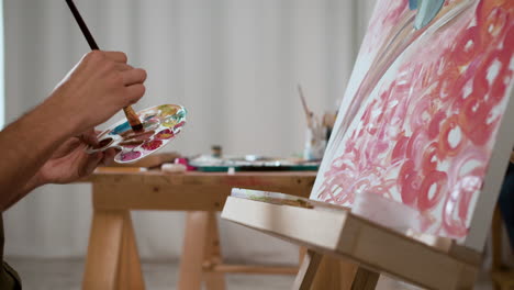 side view of man painting indoors