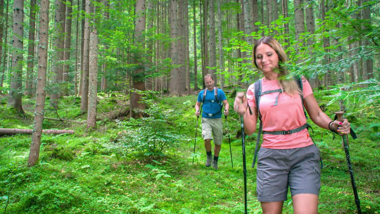 Walking through the forest in the middle of nature. Couple on a hiking adventure. Topla valley, Slovenia