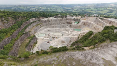 aerial view of an active open-pit quarry with heavy machinery