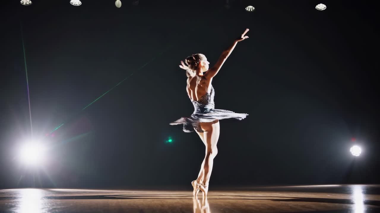 Elegant ballet dancer performing on stage, captured in a low-angle shot
