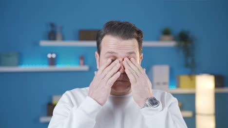 man with sore eyes from lack of sleep, having trouble seeing and opening his eyes.