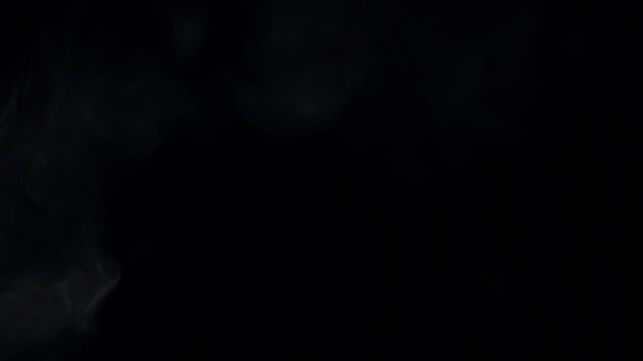 White Smoke or Vapor Expanding and Dissipating on Black Background