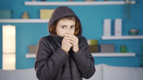 boy cold at home looking at camera.