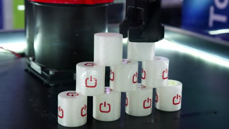 3d printed objects with power symbols in a robotic manufacturing setup