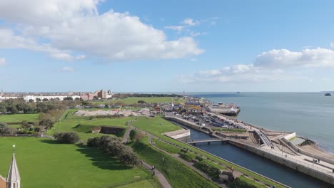 short flight over southsea common and seafront from derelict church towards d day museum on bright sunny day