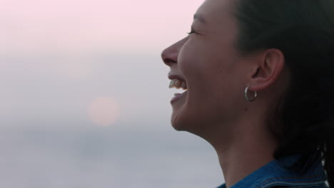 portrait of beautiful asian woman smiling enjoying carefree lifestyle exploring freedom on vacation looking happy with wind blowing hair
