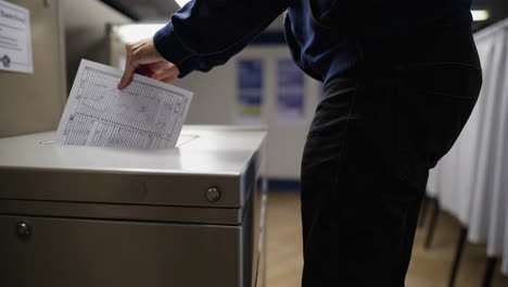 inside a polling place with voting booths and ballot box