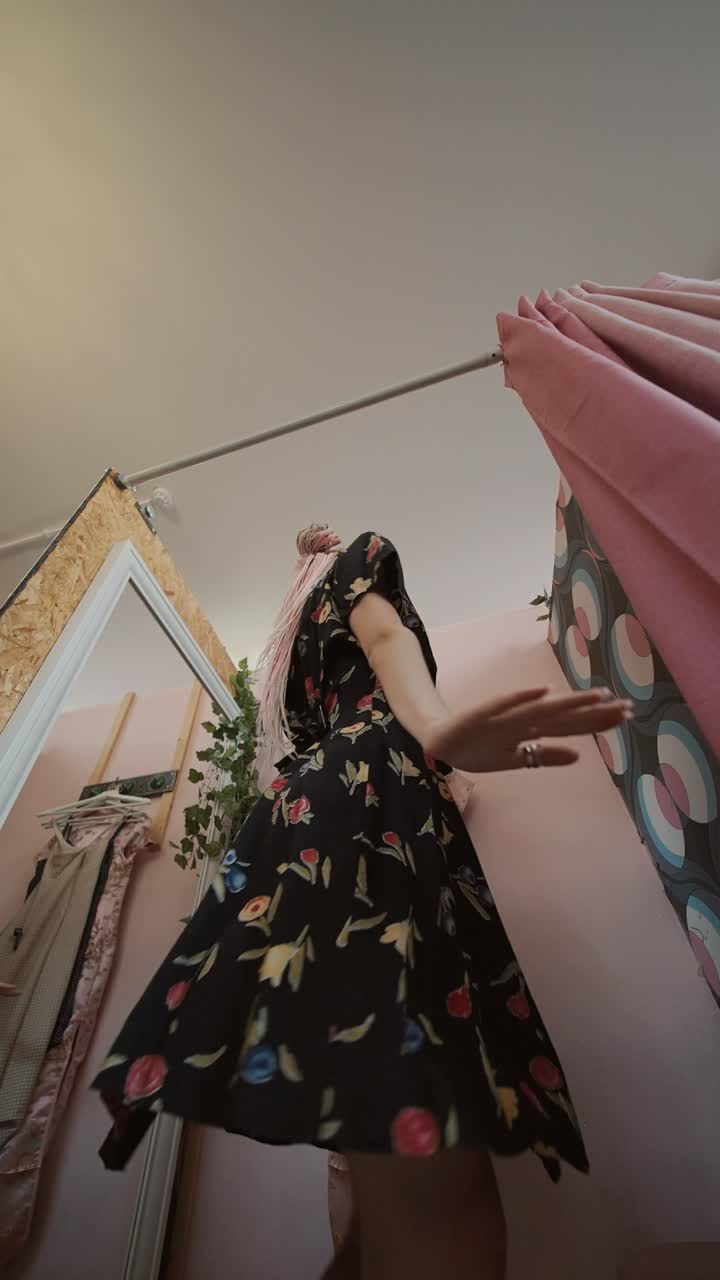 Woman in floral dress in a fitting room