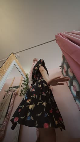 woman in floral dress in a fitting room