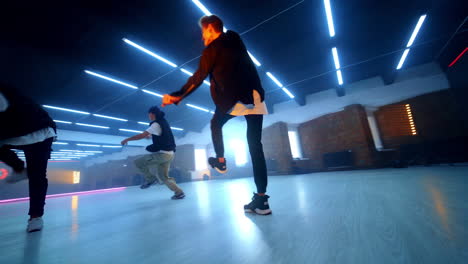 modern dance style performed by male hop hoppers. three guys dancing in studio.