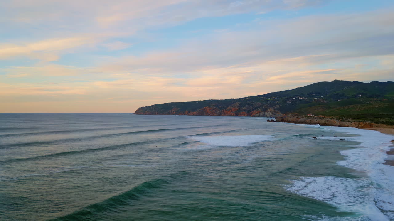 Tranquil evening ocean view with dark mountains on background. Beautiful sea
