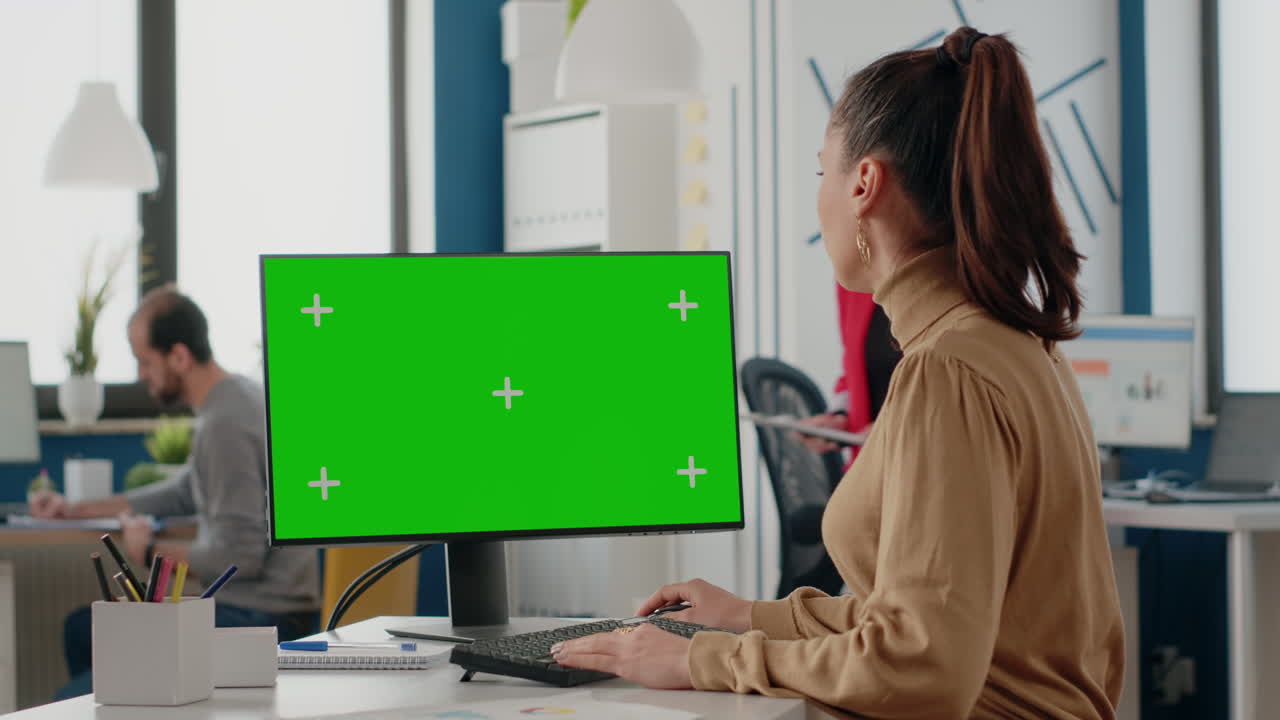 Company worker using computer with green screen
