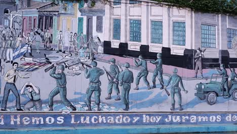 Pan-across-building-mural,-slogan-depicting-revolution-in-Nicaragua