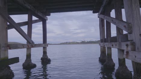 waves under wooden platform - coffs harbour pier nsw australia