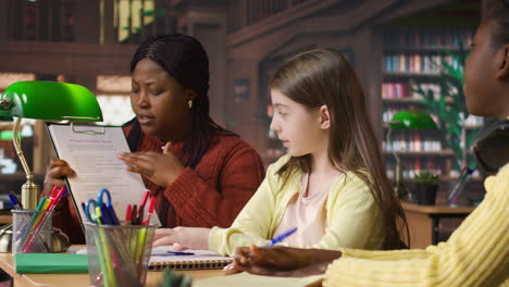 teacher instructing students in a library