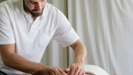 physiotherapist giving back massage to a woman