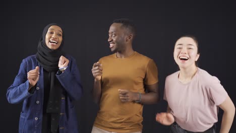 happy fun and cute three multiethnic friends dancing having fun, laughing.