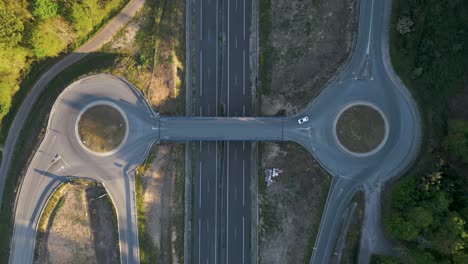 aerial view cars driving on double roundabouts in italy