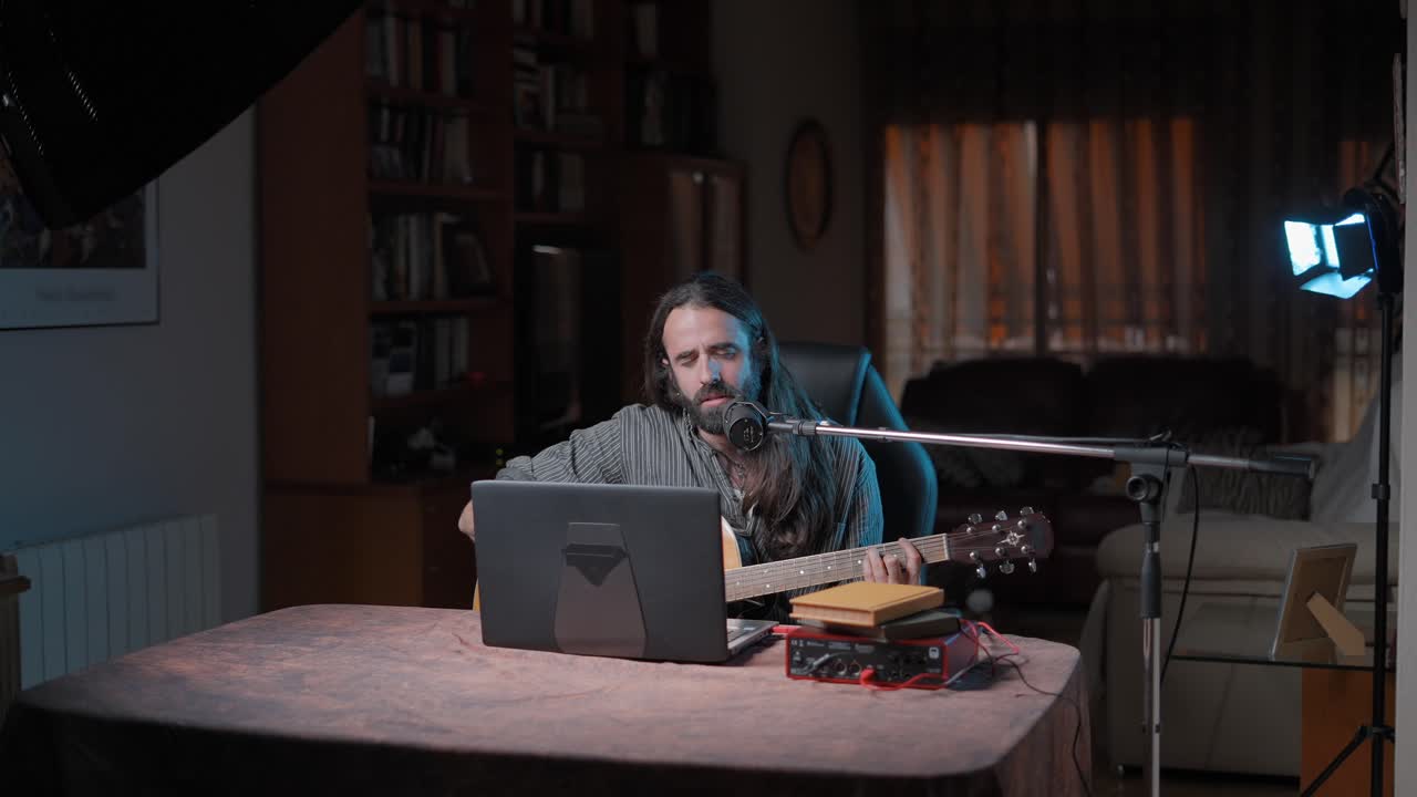 Man Singing and Playing Acoustic Guitar at Home