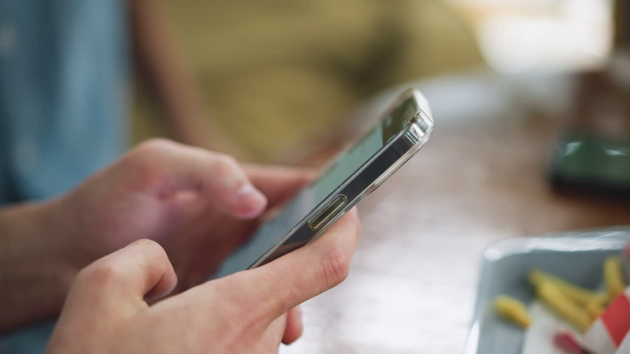 Beautiful view of new mobile with sleek display and soft lighting, closeup showing design details and reflection, modern device presentation for promotional use, external hand moving at background