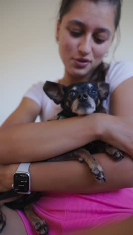 woman cuddling and bonding with her small dog