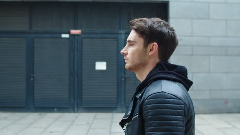 Focused-male-model-walking-on-street