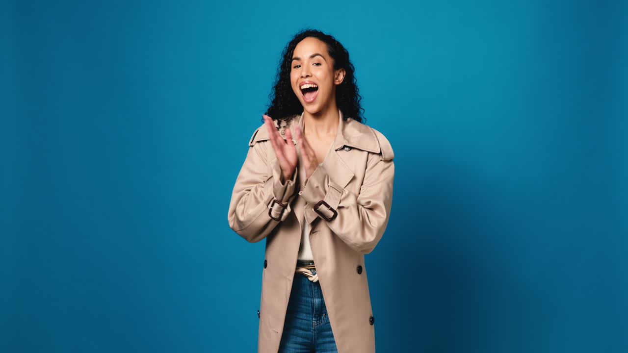 Woman in Trench Coat Clapping in Studio