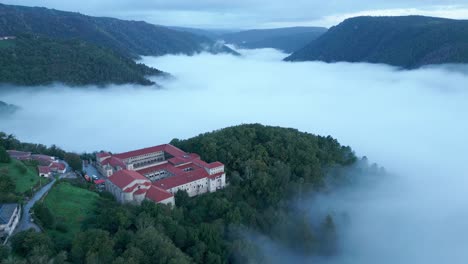 Aerial-Shot-Of-Sil-Canyon-Covered-In-Fog-And-Santo-Estevo-Monastery,-Spain