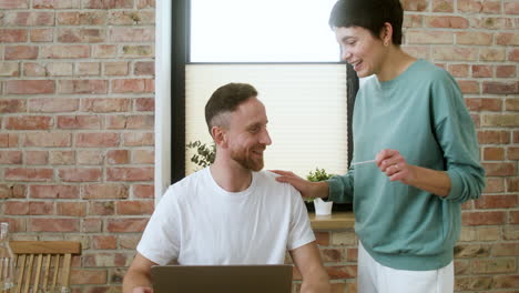 man working on laptop on dining room