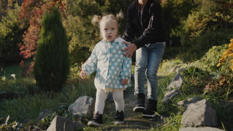 brother playing with little sister in autumn park