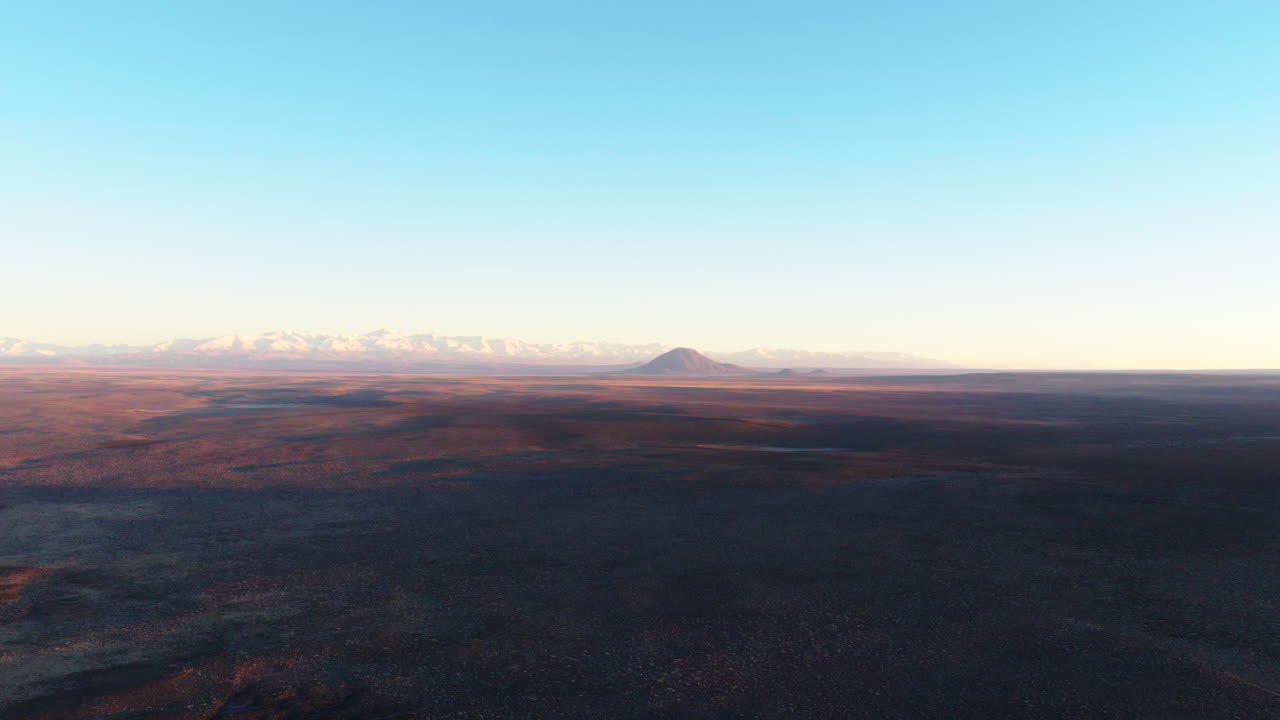 Aerial view of Diamante Volcano and the Andes over the desert plains of Mendoza, Argentina.