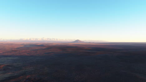 aerial view of diamante volcano and the andes over the desert plains of mendoza, argentina.