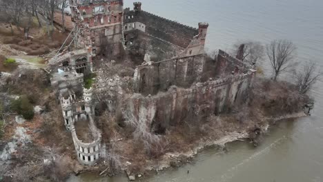 aerial drone footage approaching the ruins of an abandoned castle, and looking down into the interiour