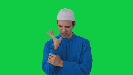 sick muslim man suffering from hand pain green screen