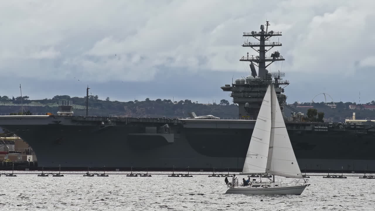 A sailboat floats on the calm water