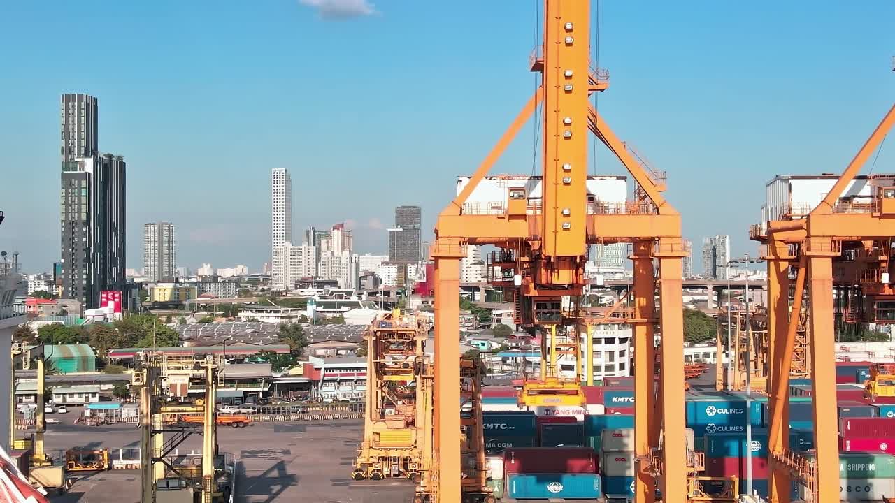View of Bangkok port with container cranes and cityscape in the background