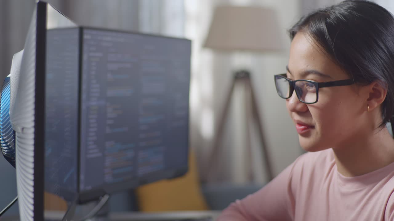 Woman Coding on Dual Monitors