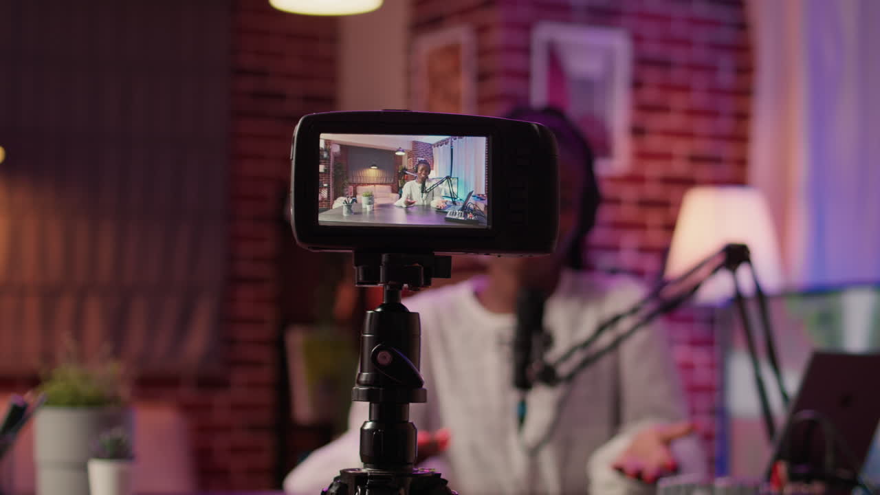 Selective focus on digital video camera screen recording african american vlogger talking to audience