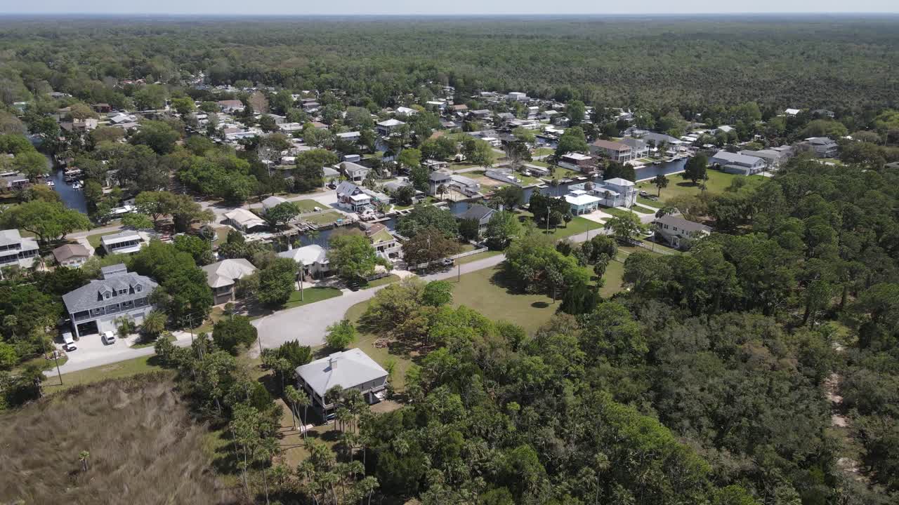 fast spin aerial from the marsh lands of the Weeki Wachee River to the Weeki Wachee Gardens subdivision that has access to it