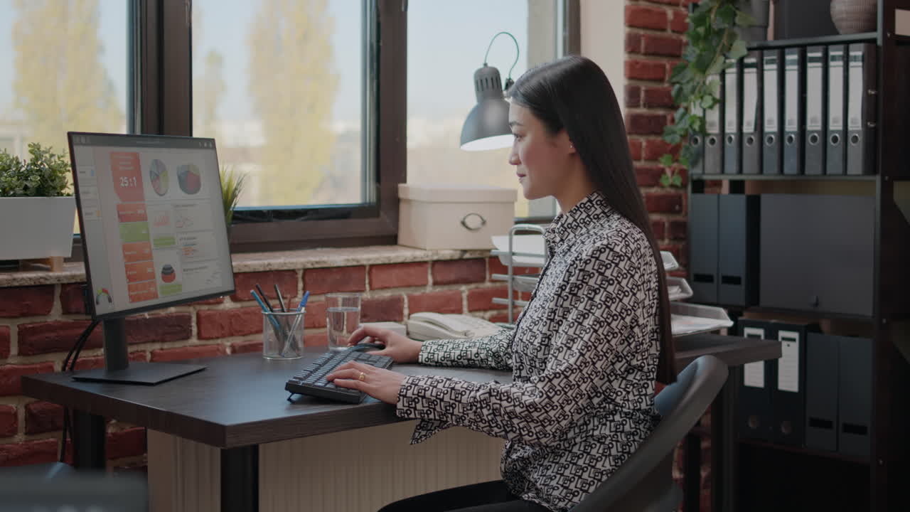 Asian business woman using computer to work on project