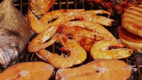 grilled shrimp, salmon, and fish on a barbecue grill