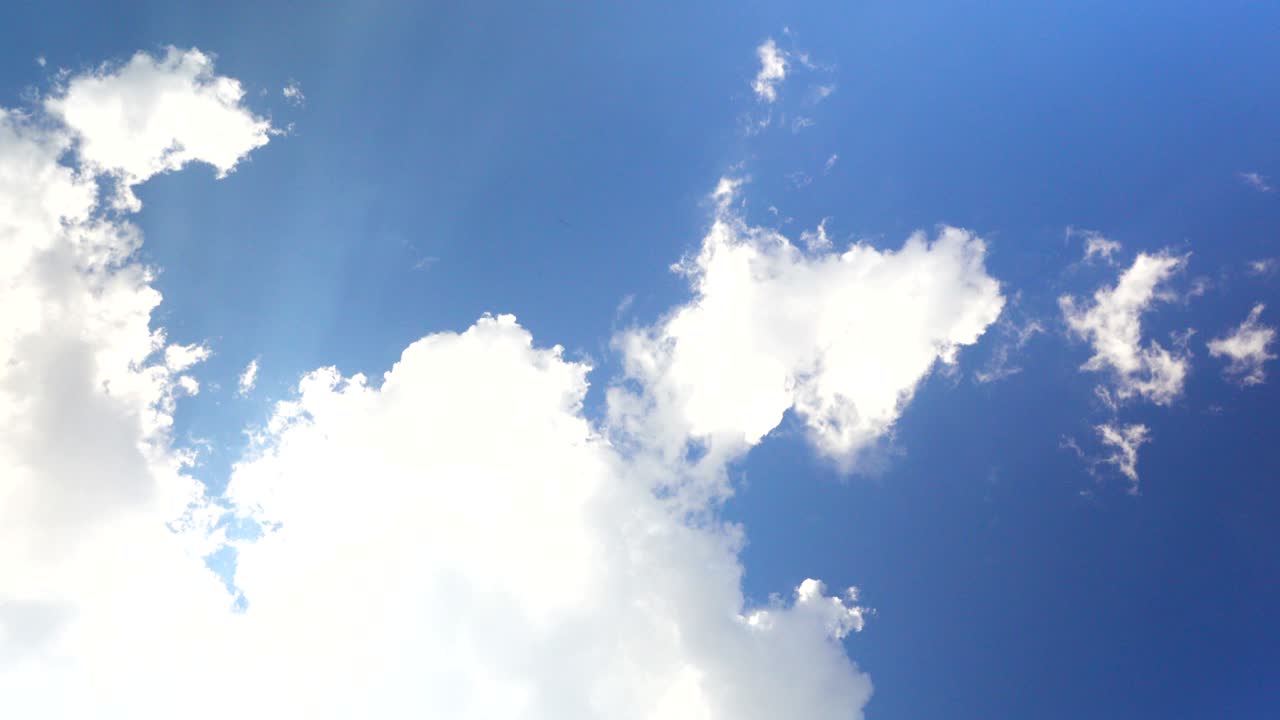 Cloudscape with bright sun shining with clouds passing