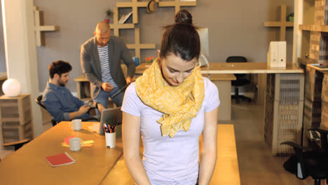 Portrait-of-female-business-executive-smiling-while-coworker-interacting-in-background