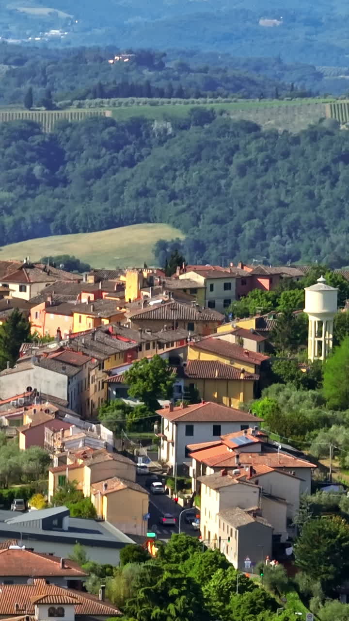 Vertical drone shot around a idyllic countryside town, summer in Tuscany, Italy