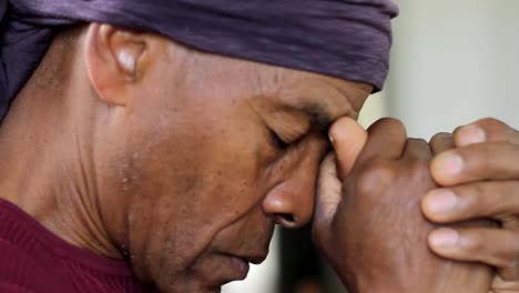 man praying to god with hands together caribbean man praying with background with people stock footage